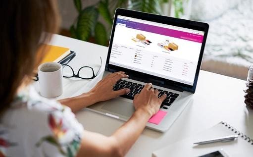 A person is using their laptop at the table