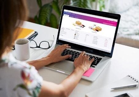 A person is using their laptop at the table